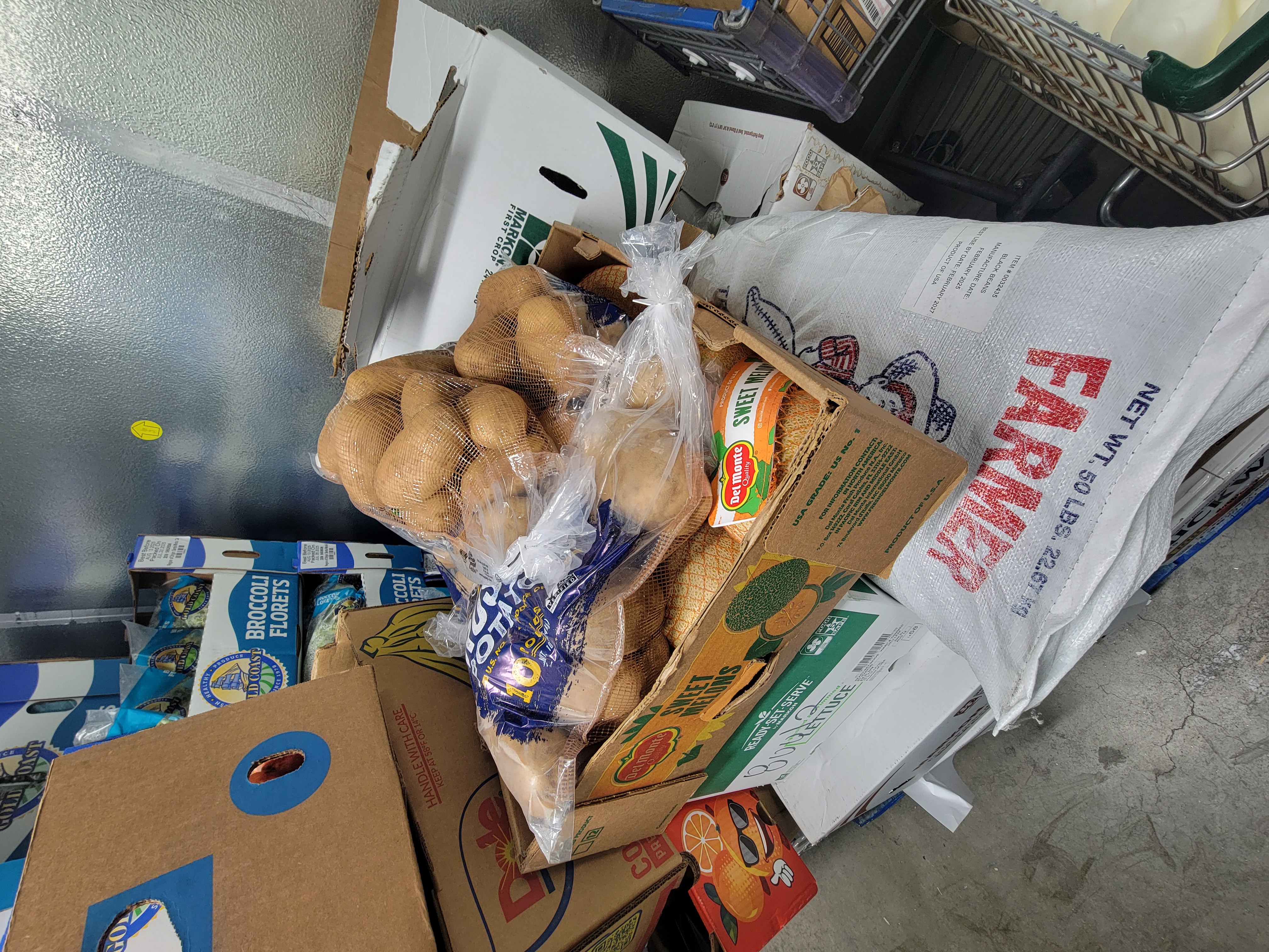 Boxes of various produce in a fridge box unit.